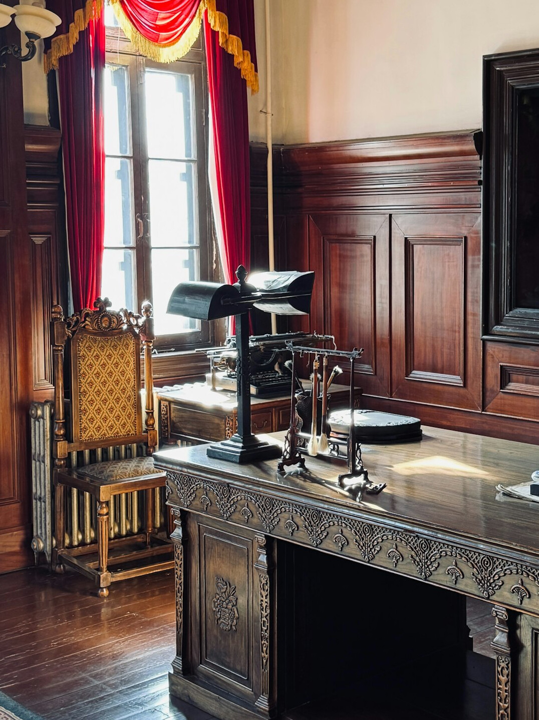 Cozy editorial office desk with vintage books and warm lighting