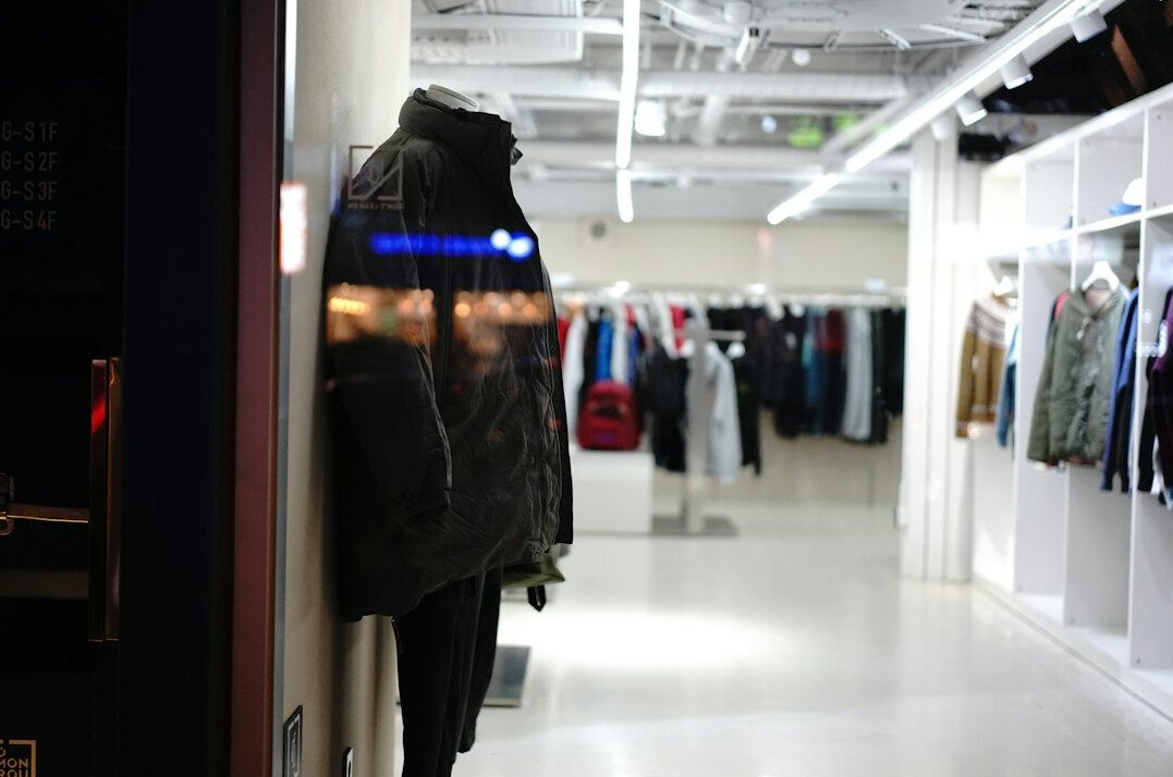 shoplifter hiding clothes under jacket