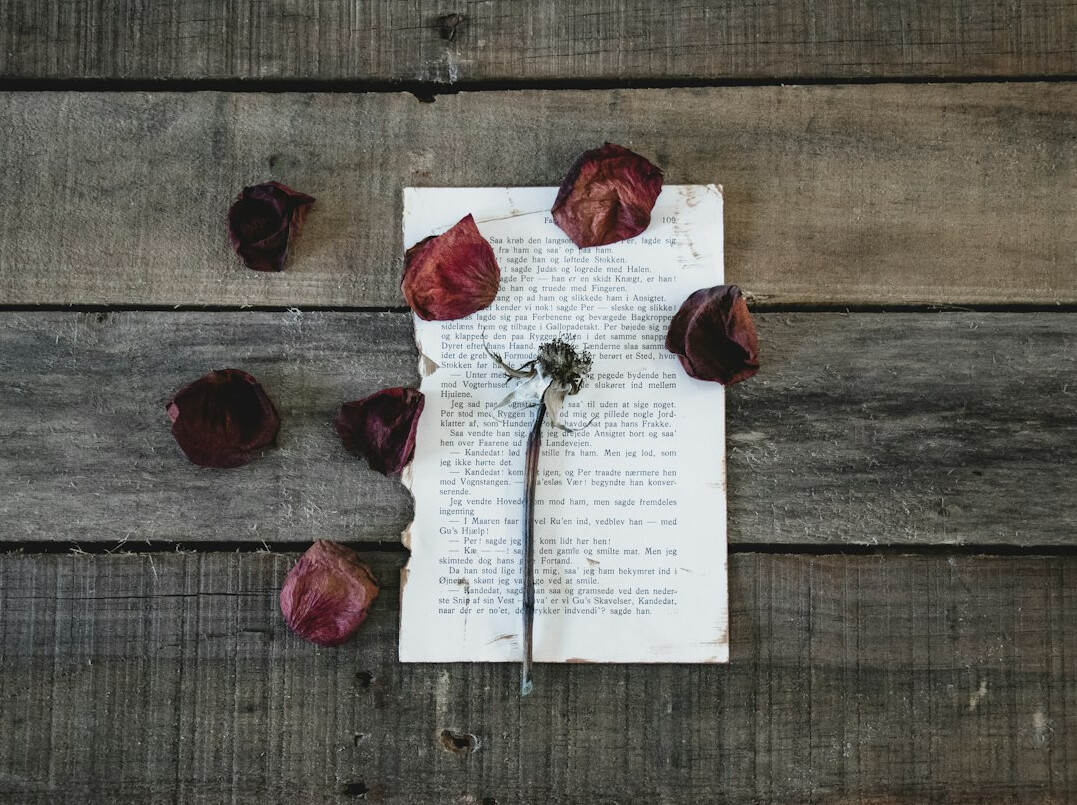 Vintage newspaper clippings and typed documents spread on a wooden table