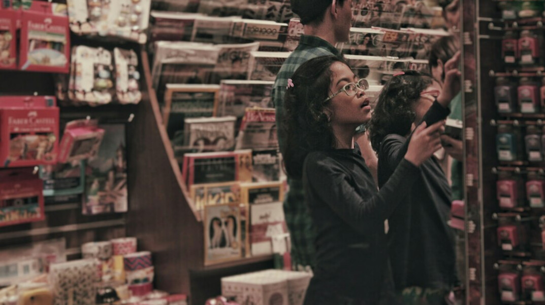 store detective watching shoplifters